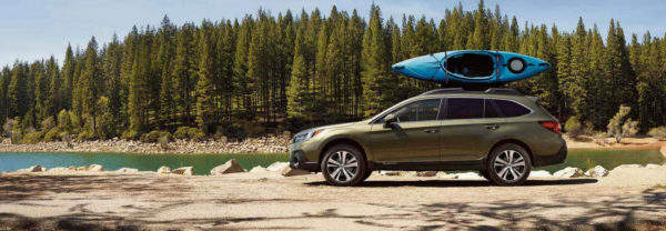 Green 2019 Subaru Outback parked lakeside