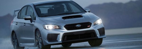 2019 Subaru WRX driving around a curve in the road